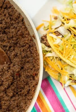 A skillet with Taco Bell meat next to a plate of homemade Taco Bell tacos