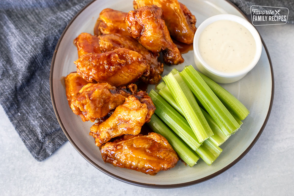 Plate with Winger's Wings with Freakin Amazing Sauce and celery sticks. Ranch on the side.