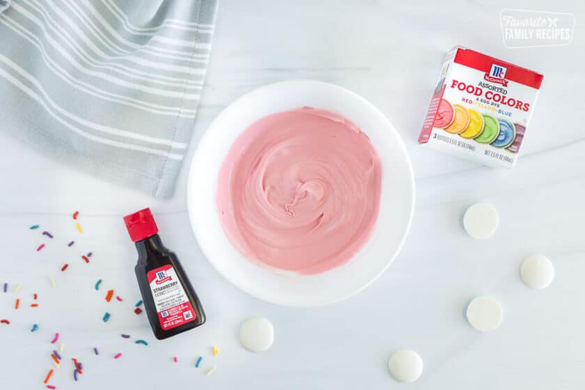 Melted white chocolate mixed with red food coloring and strawberry extract to make a smooth, liquid, pink chocolate.