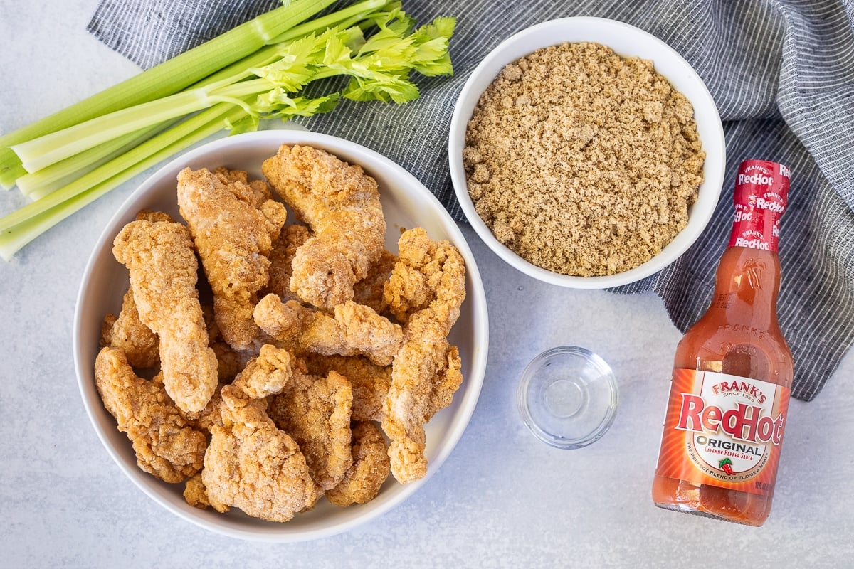 Ingredients to make Winger's Sticky Fingers and Freakin Amazing Sauce including frozen chicken strips, brown sugar, Frank's Red Hot sauce and water.