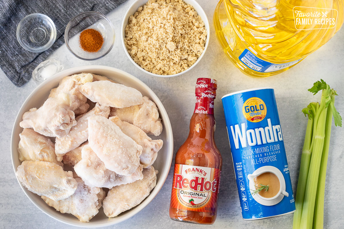 Ingredients to make Winger's Wings with Freakin Amazing Sauce including chicken, Frank's Redhot sauce, Wondra flour, brown sugar, cayenne pepper, water, salt and oil.