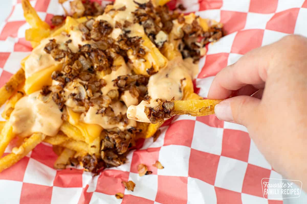 A close up of an In-N-Out French fry with animal style toppings