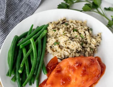 Plate of Apricot Chicken, rice and green beans.