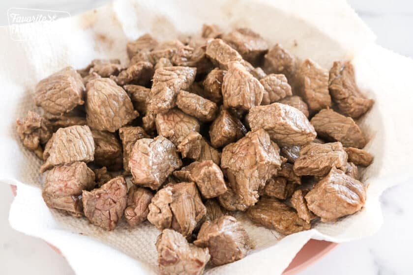 seared chunks of meat on a plate with a paper towel