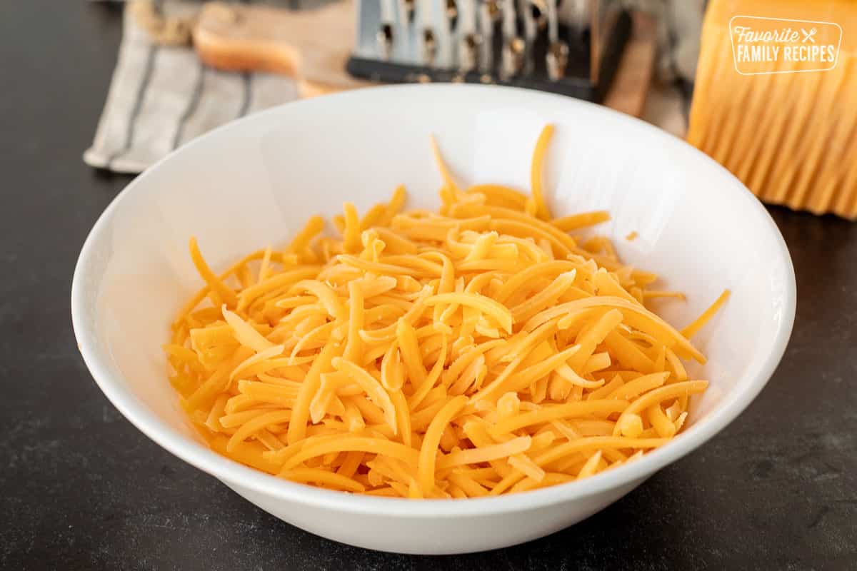 Bowl of grated cheddar cheese for freezing.