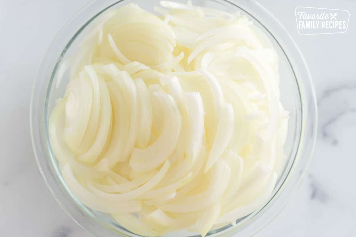 thinly sliced onions in a bowl