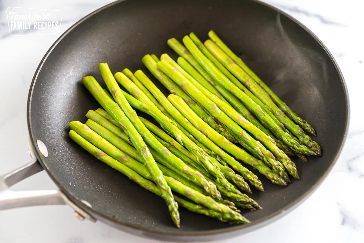 Asparagus sautéing in a pan