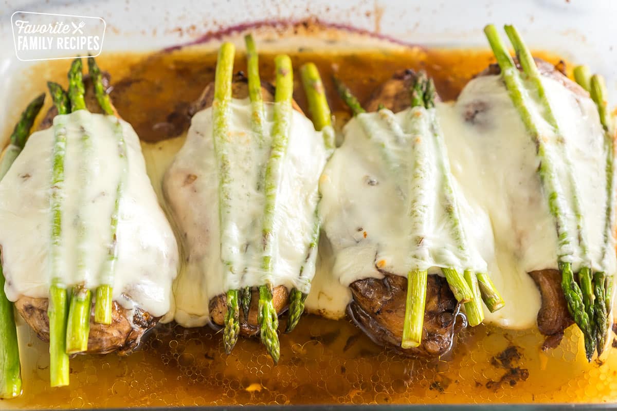 Chicken breasts with asparagus and melted cheese