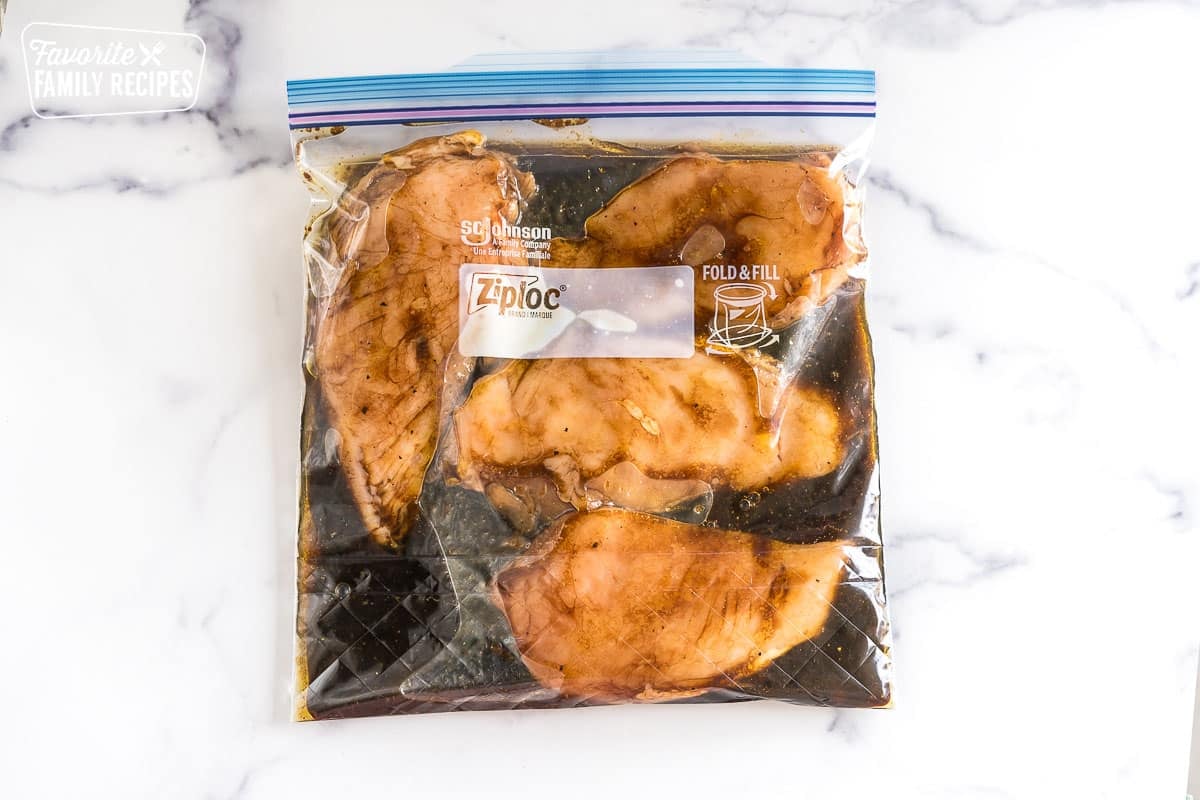 Chicken breasts marinating in a ziplock bag.