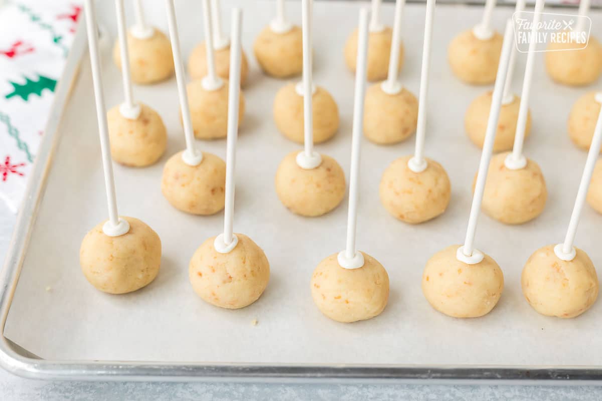 Chilled Christmas Cake Pops on a baking sheet lined with parchment paper.