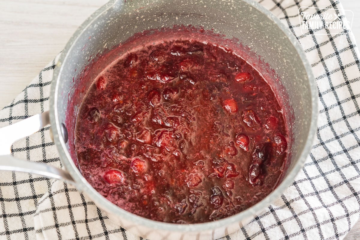 cranberries cooking in a saucepan