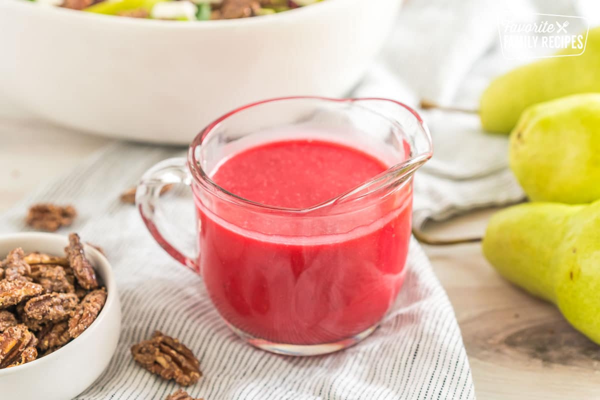 pinkish red salad dressing in a small pitcher
