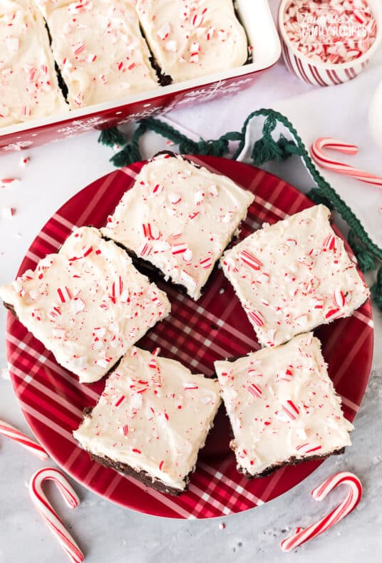 Plate with White Chocolate Peppermint Brownies and candy canes crushed on top.