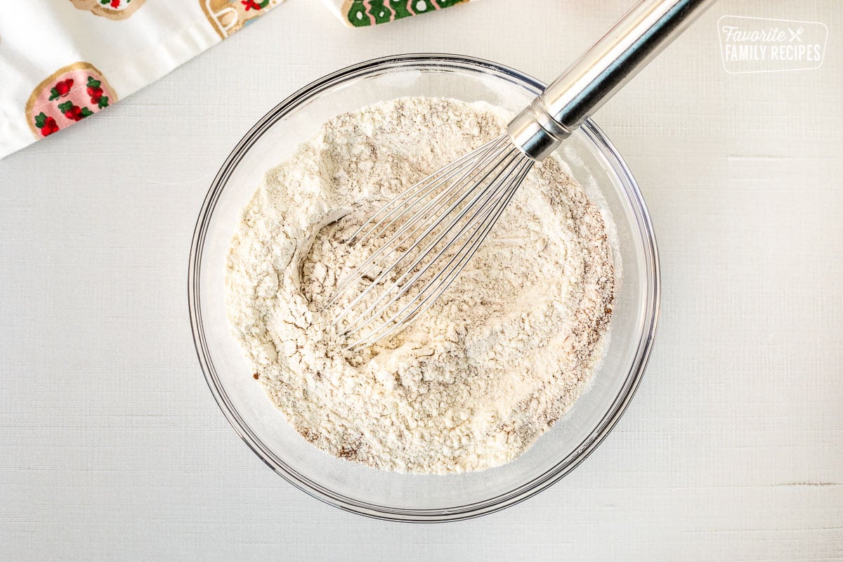 Mixing bowl with dry ingredients and whisk.