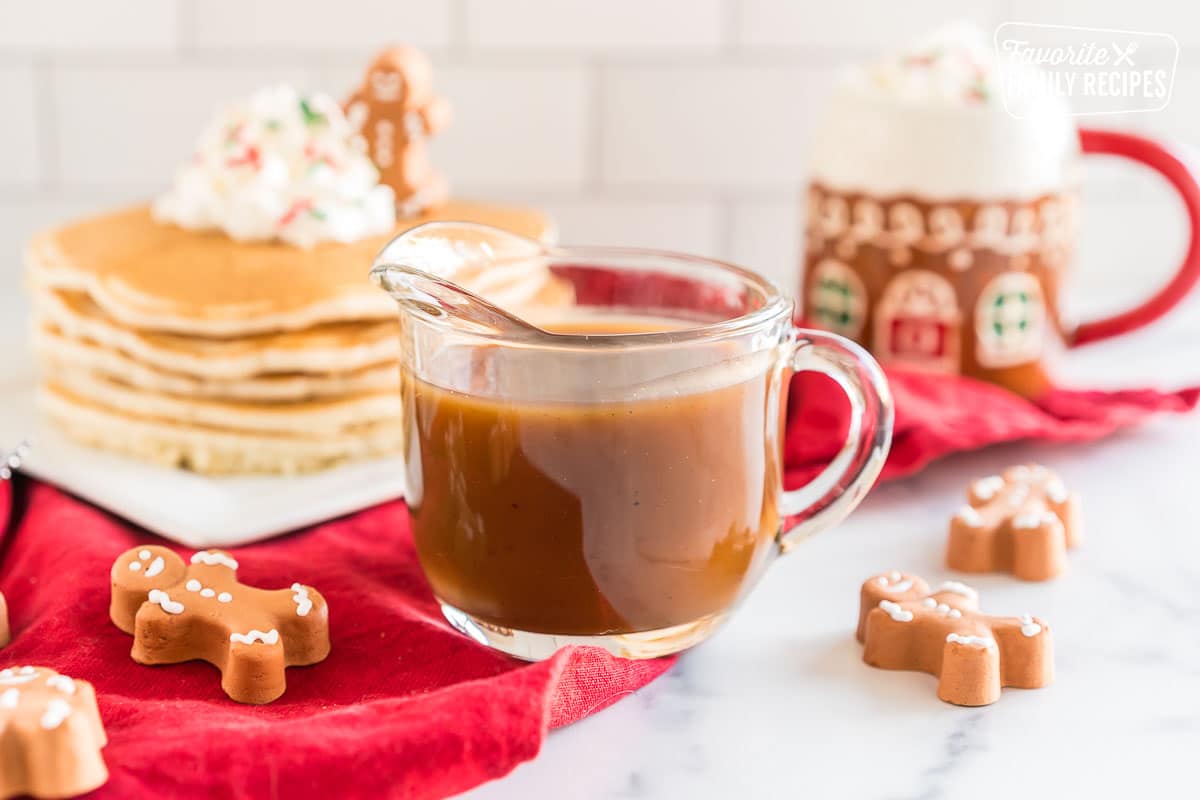 A small glass pitcher of gingerbread syrup