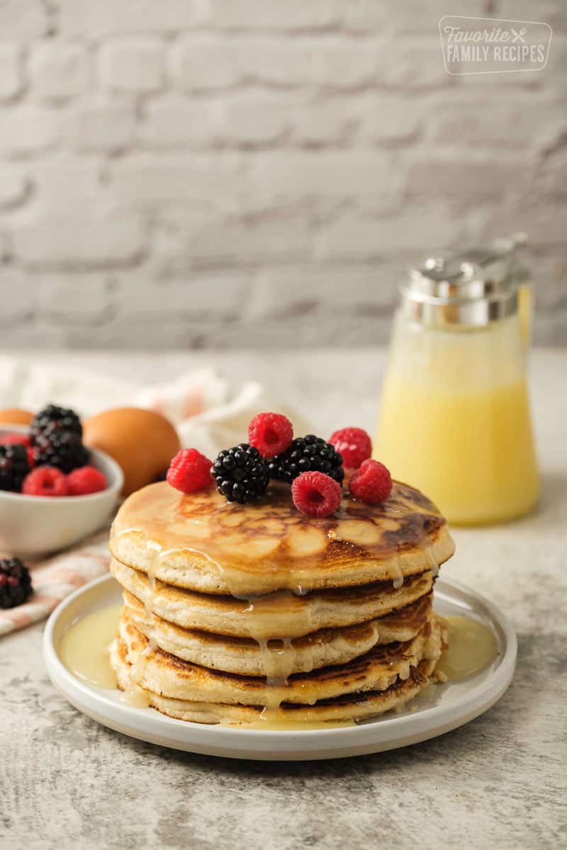 Stack of Gluten Free pancakes with syrup and berries