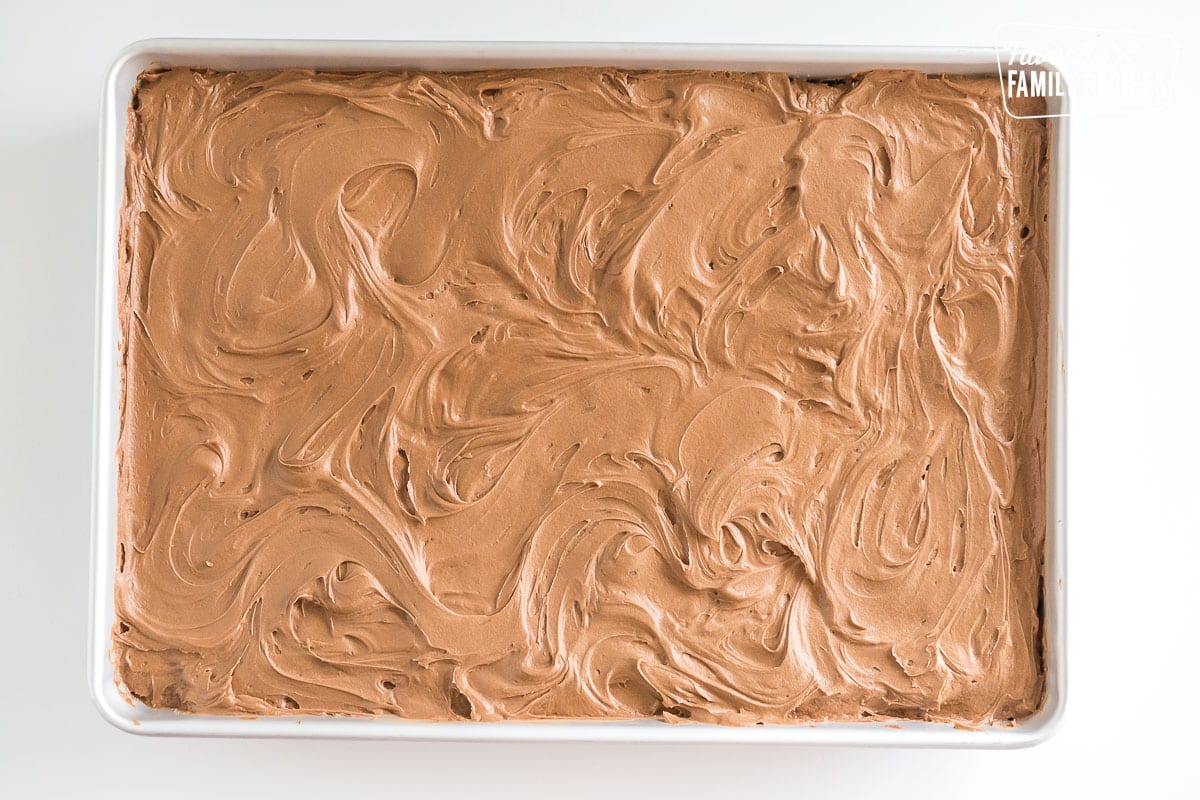 vanilla cake with chocolate buttercream frosting in a baking dish