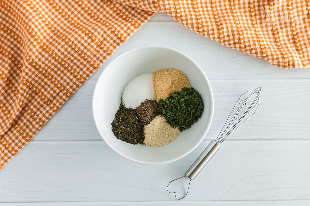 Ranch dressing seasoning in a white bowl with a small whisk on the side.