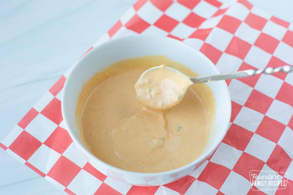 A spoon taking a scoop our of a bowl of In-N-Out sauce