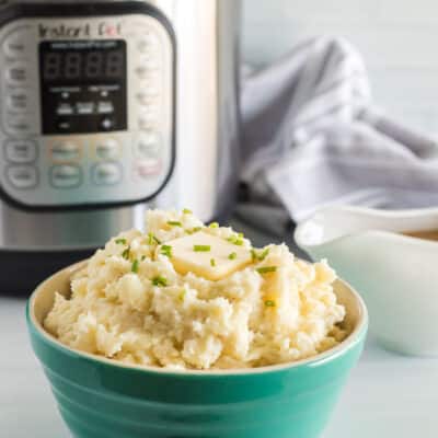 Instant pot mashed potatoes with a slice of butter sitting on top of the potatoes.