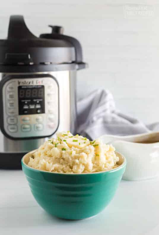Instant pot mashed potatoes in a green bowl.