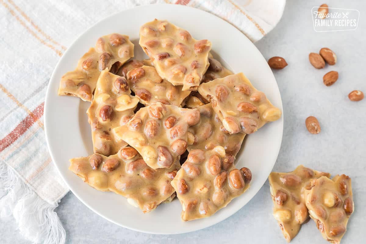 Microwave Peanut Brittle on a plate broken up in pieces.