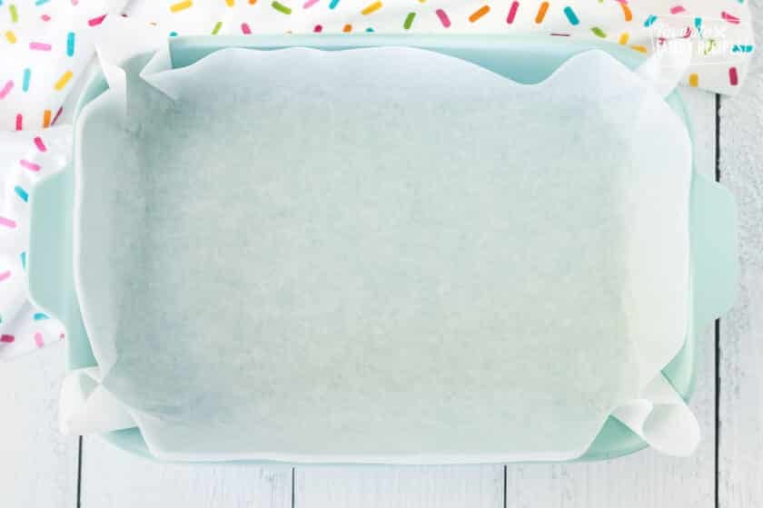 Baking dish lined with parchment paper and non stick cooking spray.