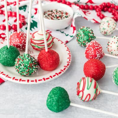 Plate of Christmas Cake Pops decorated with sprinkles.