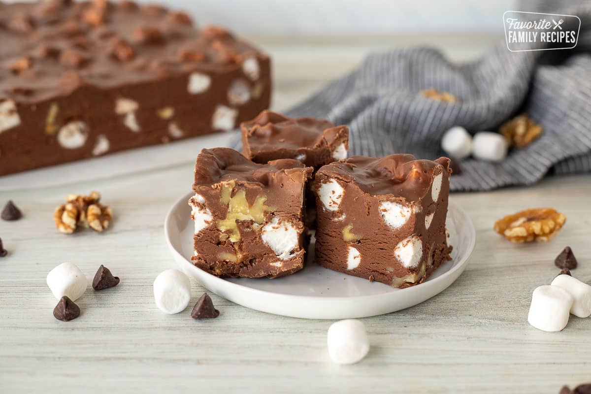 Three pieces of Marshmallow Rocky Road Fudge on a plate.