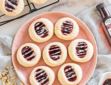 a plate of raspberry thumbprint cookies