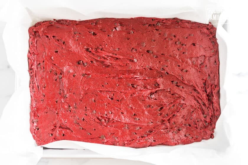 batter in a baking dish lined with parchment paper