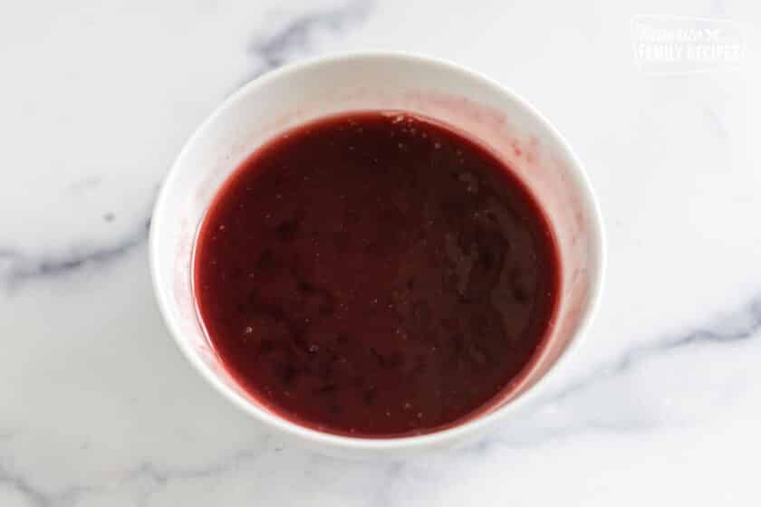 a bowl of raspberry jam topping
