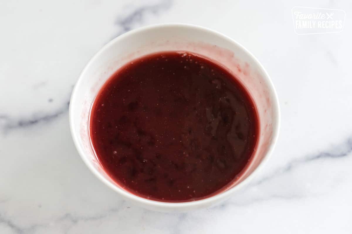 a bowl of raspberry jam topping