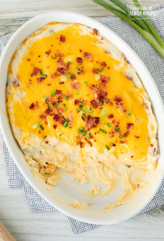 Scooped out Loaded Mashed Potatoes from a casserole dish.