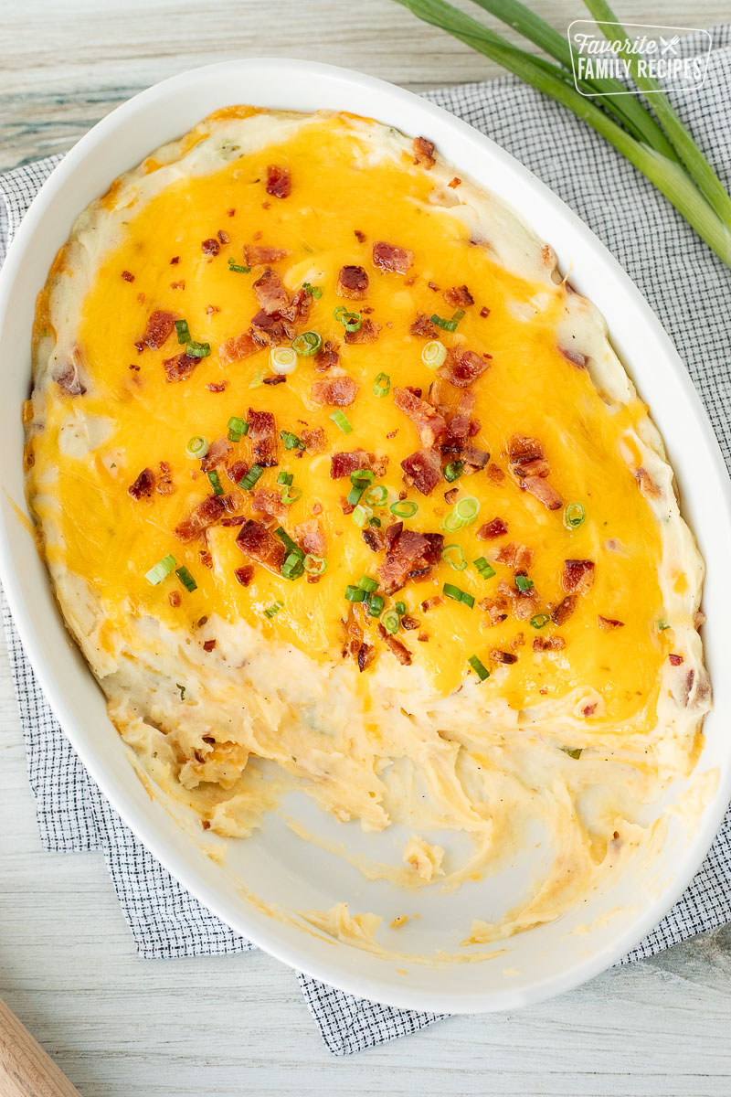 Scooped out Loaded Mashed Potatoes from a casserole dish.