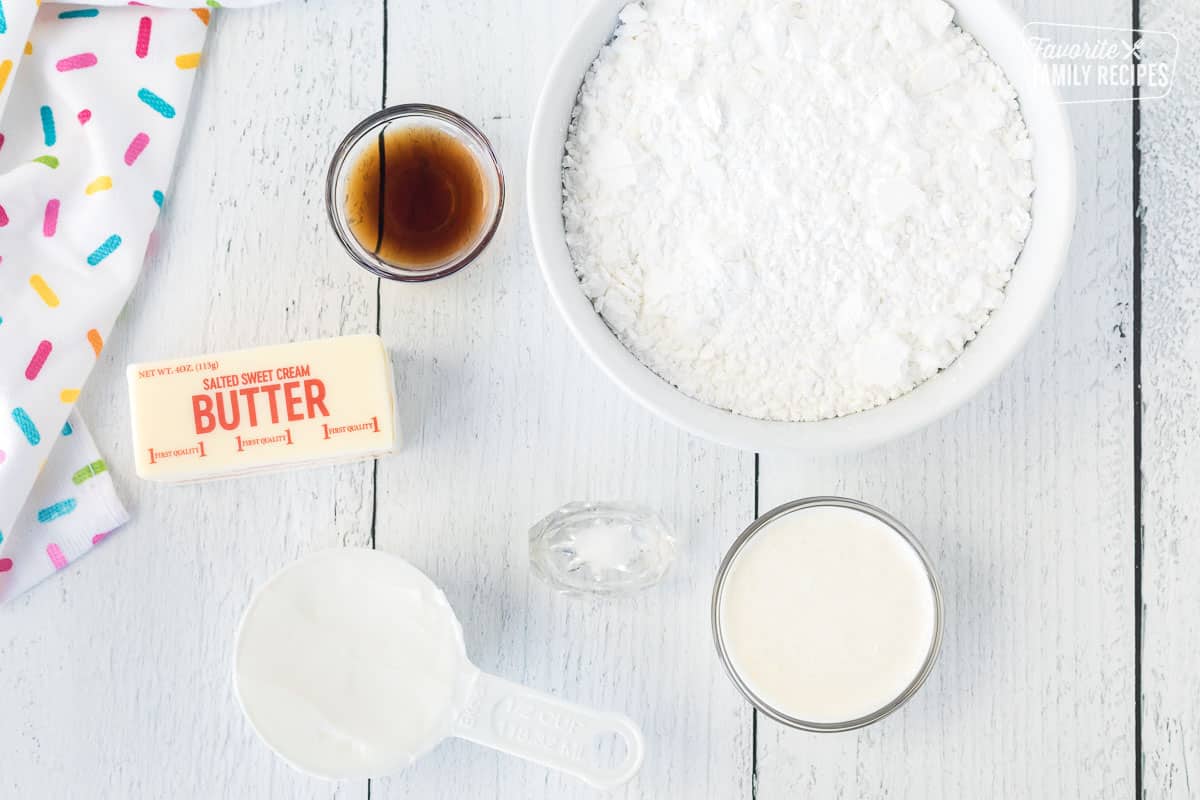 Ingredients to make Sugar Cookie Bar frosting including powdered sugar, vanilla, butter, shortening, salt and cream.