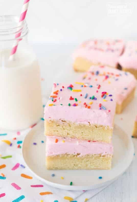 Two Sugar Cookie Bars stacked on a plate.