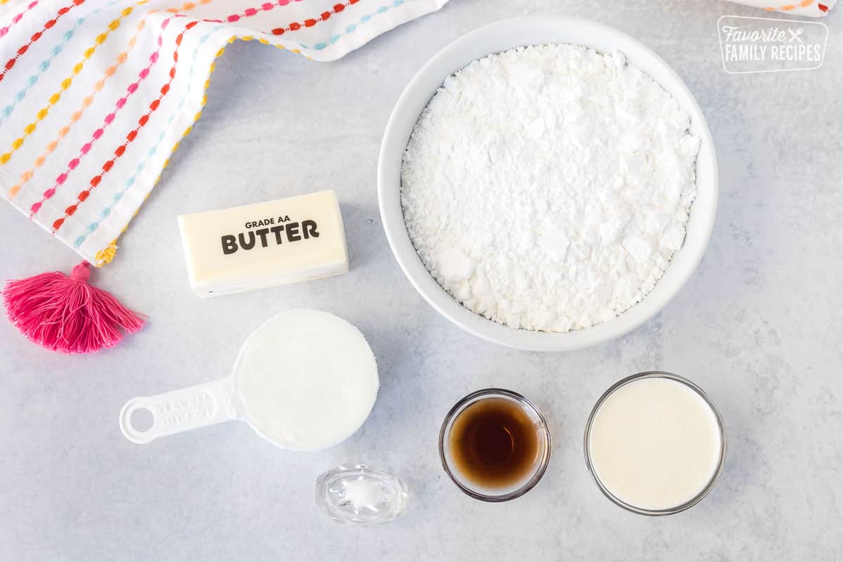 Ingredients to make Sugar Cookie Frosting including butter, shortening, powdered sugar, vanilla, salt and cream.