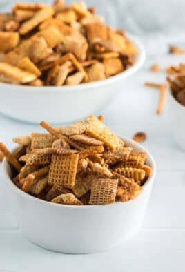 A side view of three bowls of chex mix