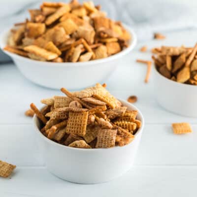 A side view of three bowls of chex mix