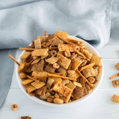 A vertical shot of a bowl of chex mix