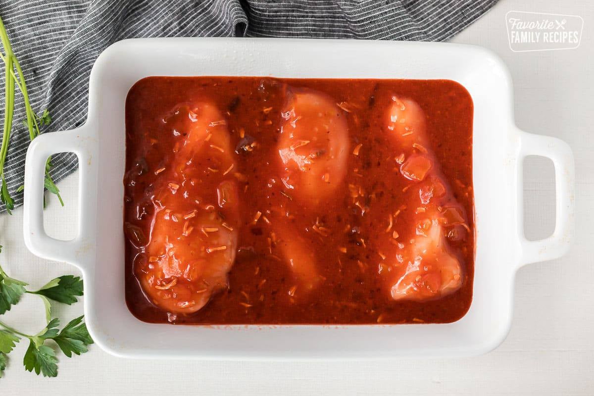 Baking dish with chicken breasts and apricot preserves marinade.