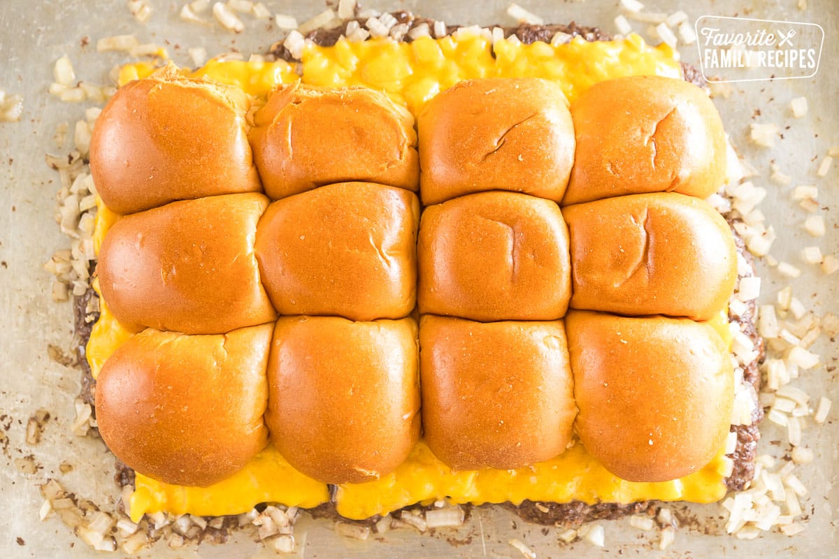 Ground beef topped with onions, cheese, and buns