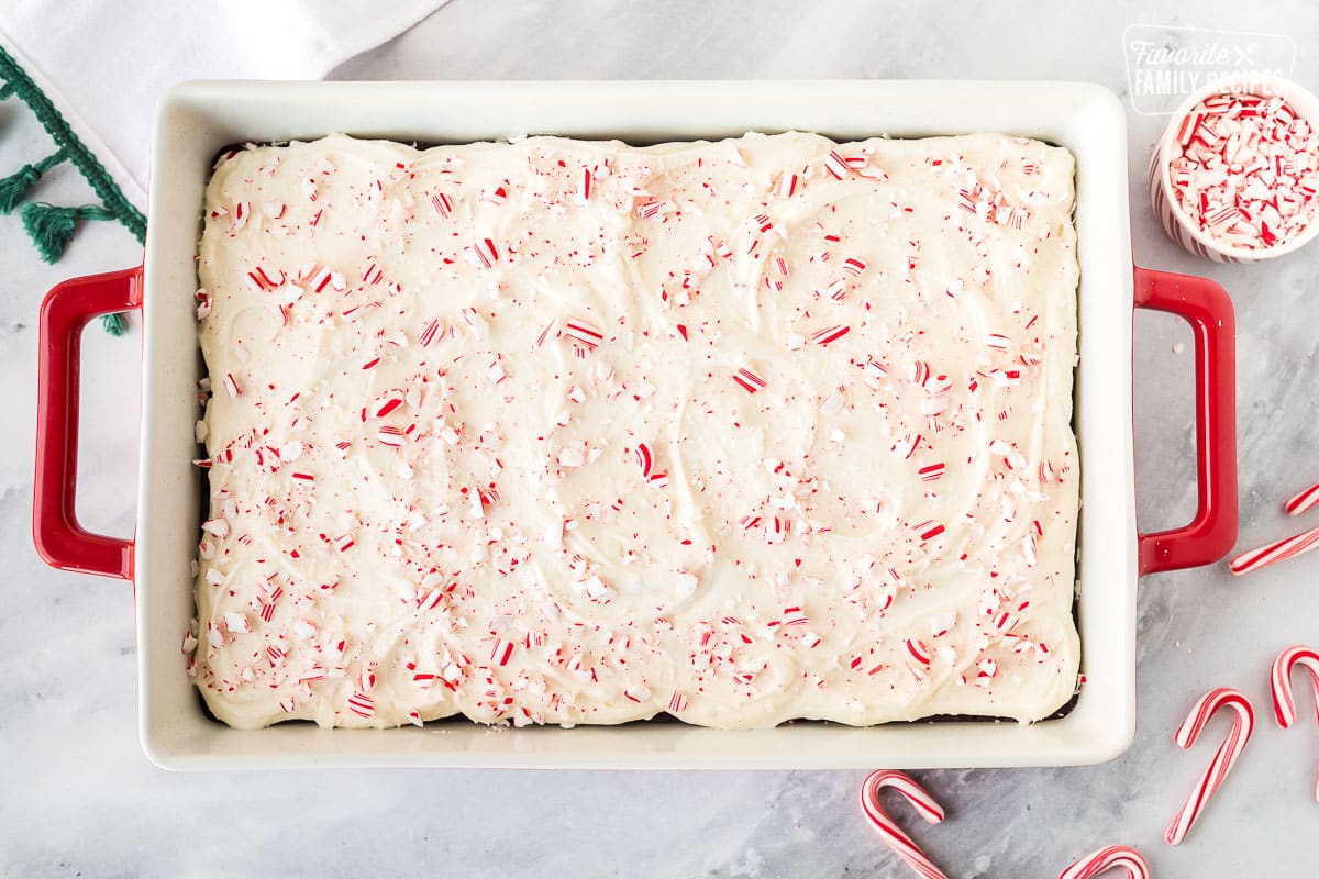 Baking dish of White Chocolate Peppermint Brownies sprinkled with crushed candy canes.