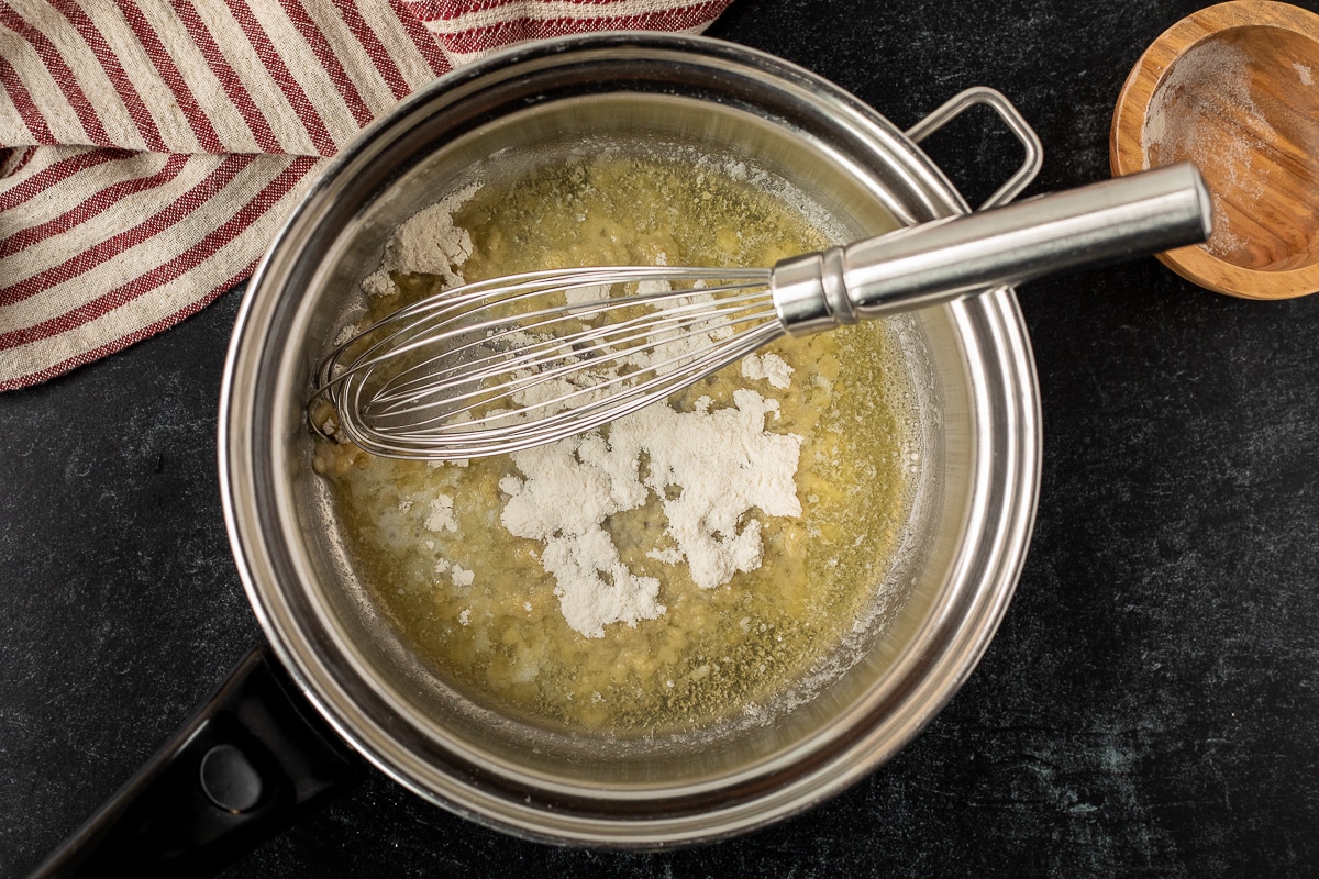 Pan with melted butter and flour with a whisk.