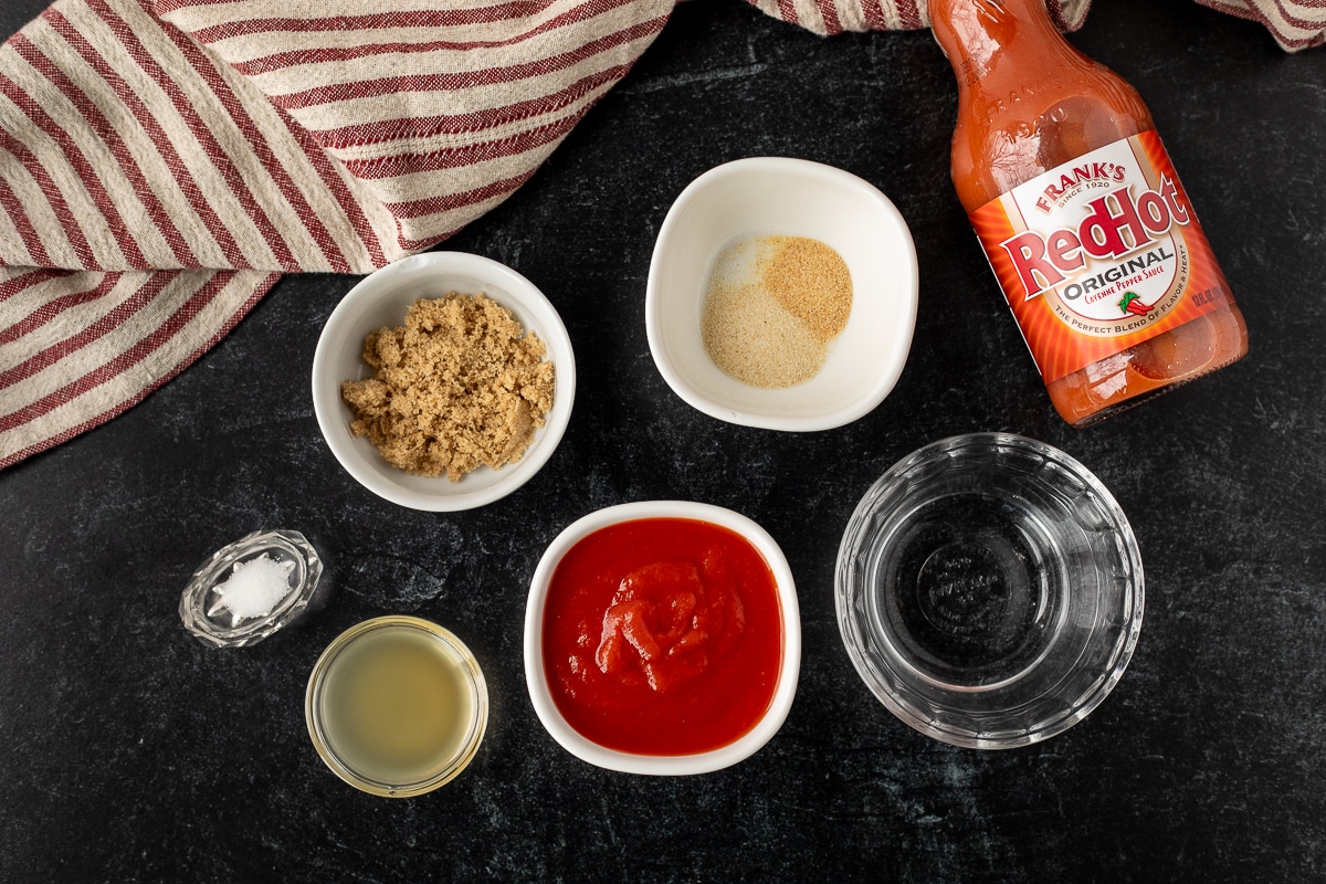 Ingredients to make Arby's red sauce including brown sugar, ketchup, salt, apple cider vinegar, water, garlic powder, onion powder and Frank's Red Hot sauce.