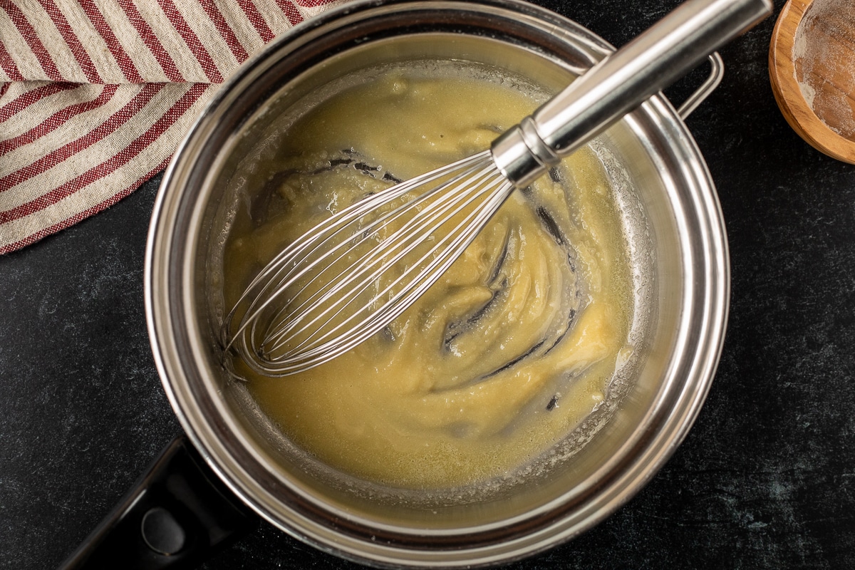Pan with roux and a whisk.