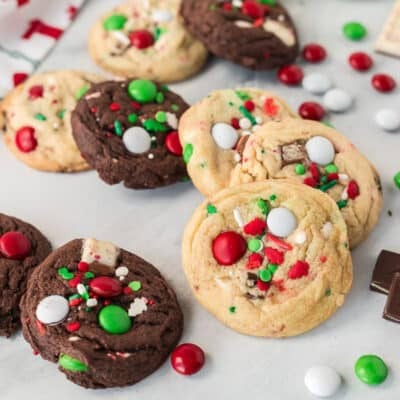 Assortment of regular and chocolate Elf Cookies next to chocolate candies.