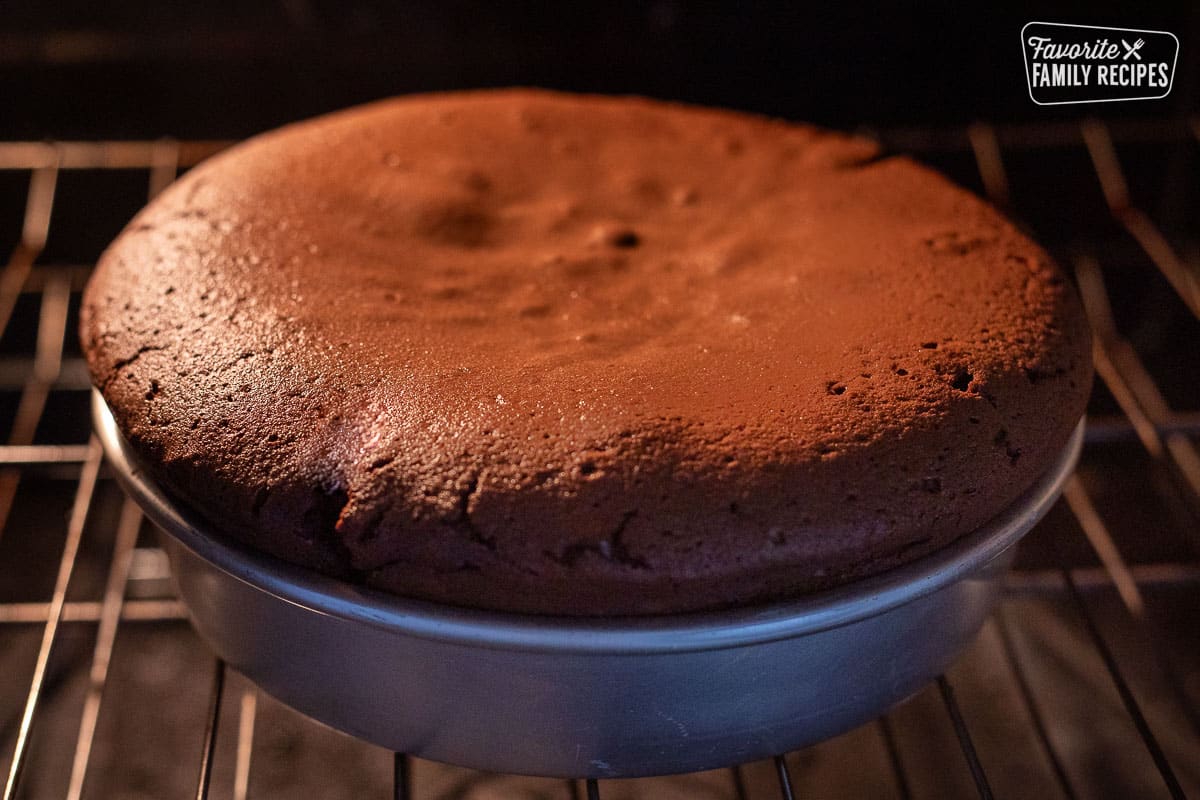 Gluten Free Chocolate Cake baking in the over with the cake rising.