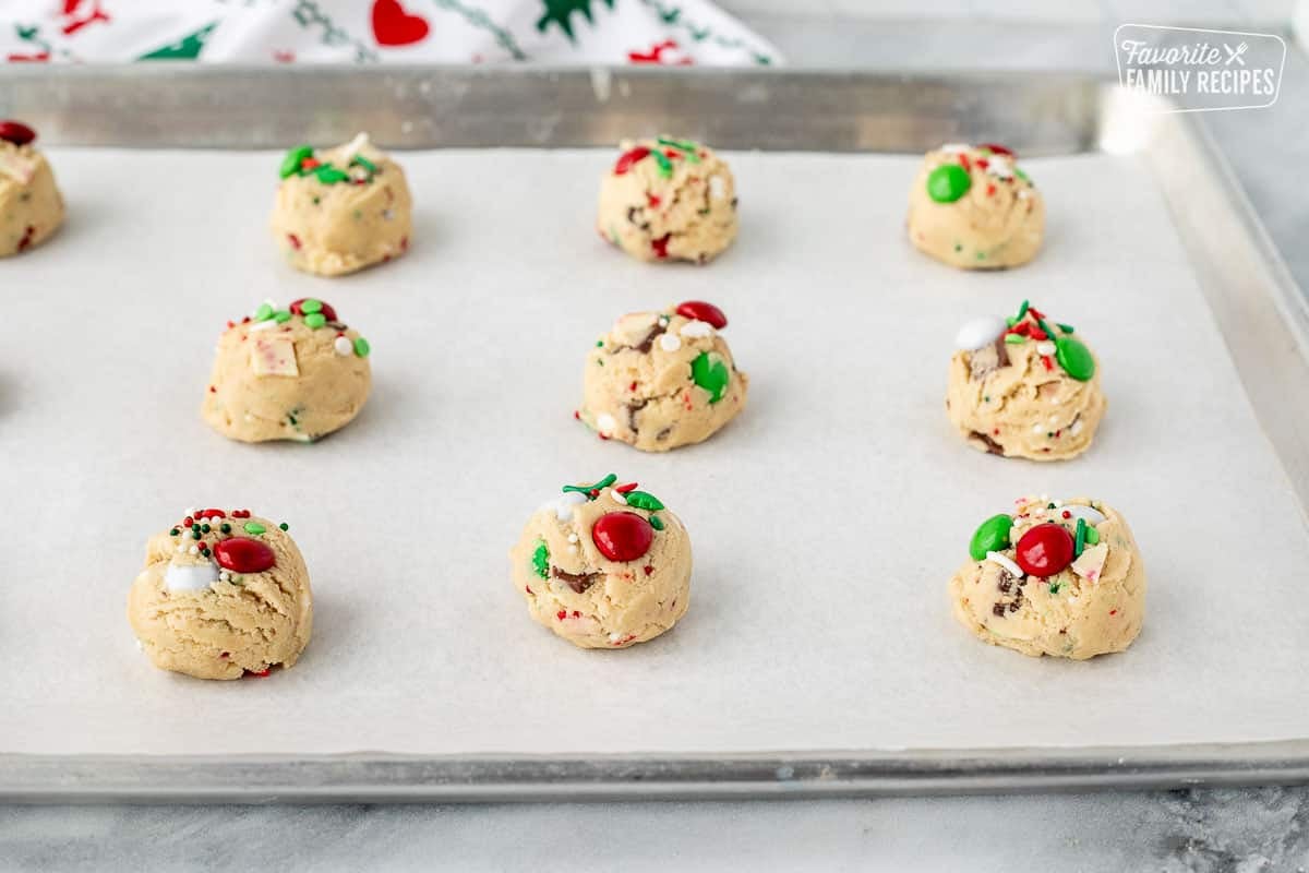 Dough balls on a baking sheet lined with parchment paper.